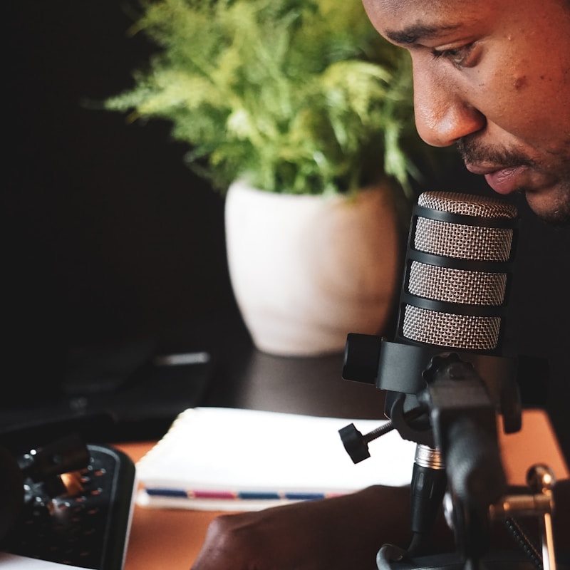 Creator with headphones reviewing content on a computer screen